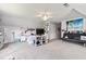Spacious bedroom with neutral tones, fan, and comfortable sleeping and seating areas at 242 Sandhurst Ct, Suwanee, GA 30024