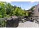 Outdoor deck features seating and a grill for entertaining and outdoor dining at 242 Sandhurst Ct, Suwanee, GA 30024