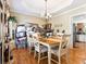 Bright dining room featuring a chandelier, hardwood floors, and elegant trim details at 242 Sandhurst Ct, Suwanee, GA 30024
