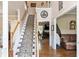 Inviting foyer with staircase, hardwood floors, and high ceilings that create a grand entrance at 242 Sandhurst Ct, Suwanee, GA 30024