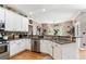 Modern kitchen featuring stainless steel appliances, granite countertops, and ample cabinet space at 242 Sandhurst Ct, Suwanee, GA 30024