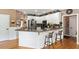 Eat-in kitchen with stainless steel appliances, granite counters, bar seating, and ample storage at 242 Sandhurst Ct, Suwanee, GA 30024
