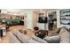 Open-concept living space with comfortable seating, built-in shelving, and natural light at 242 Sandhurst Ct, Suwanee, GA 30024