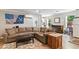 Cozy living room featuring a comfortable sectional sofa and natural light from the windows at 242 Sandhurst Ct, Suwanee, GA 30024
