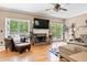 Spacious living room with fireplace, hardwood floors, and large windows offering natural light at 242 Sandhurst Ct, Suwanee, GA 30024