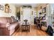 Cozy living room features hardwood floors, a comfortable sofa, and a bright workspace at 242 Sandhurst Ct, Suwanee, GA 30024