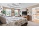 Cozy main bedroom with plush carpet, natural lighting, and stairs leading to the next level at 242 Sandhurst Ct, Suwanee, GA 30024