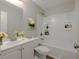 A bathroom with white cabinets, a mirror and a shower over tub with white tiling at 2918 Pavia Circle, Austell, GA 30106