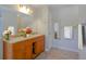 Bright bathroom showcasing a wood vanity with double sinks and decorative flowers at 2918 Pavia Circle, Austell, GA 30106
