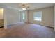 Large carpeted bedroom featuring multiple windows and a ceiling fan at 2918 Pavia Circle, Austell, GA 30106