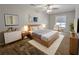 Bright bedroom with wooden furniture, white rug, stylish decor and a ceiling fan at 2918 Pavia Circle, Austell, GA 30106