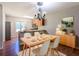 Cozy dining area featuring hardwood floors, a modern chandelier, and a kitchen island with barstool seating at 2918 Pavia Circle, Austell, GA 30106