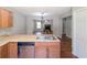 Bright kitchen open to living room featuring stainless steel appliances, and light wood cabinets and floors at 2918 Pavia Circle, Austell, GA 30106
