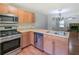 Bright kitchen features stainless steel oven and microwave, and light wood cabinets, open to living room at 2918 Pavia Circle, Austell, GA 30106