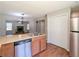 Bright kitchen open to living room featuring stainless steel appliances, and light wood cabinets at 2918 Pavia Circle, Austell, GA 30106