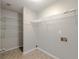 Neat laundry area with white wire shelving, hookups, and neutral flooring at 2918 Pavia Circle, Austell, GA 30106