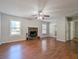 Spacious living room with hardwood floors, a fireplace, a ceiling fan, and natural lighting at 2918 Pavia Circle, Austell, GA 30106