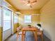 Sunroom features yellow walls, ceiling fan, tile floors, table and chairs at 2918 Pavia Circle, Austell, GA 30106