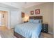 A well-lit bedroom featuring a queen bed with blue bedding, two side tables, and stylish decor at 3040 Peachtree Nw Rd # 1013, Atlanta, GA 30305