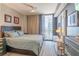 Bedroom featuring a comfortable bed, city views, and contemporary furnishings at 3040 Peachtree Nw Rd # 1013, Atlanta, GA 30305