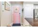 Cozy apartment entryway with pink door, dark rug, and adjacent kitchen bar at 3040 Peachtree Nw Rd # 1013, Atlanta, GA 30305