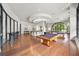 Well-lit game room with a pool table, seating area, and large windows at 3040 Peachtree Nw Rd # 1013, Atlanta, GA 30305