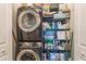 Efficient laundry closet features front-load washer, dryer, and organized shelving at 3040 Peachtree Nw Rd # 1013, Atlanta, GA 30305