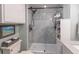 Close-up of the shower featuring frameless shower door, modern fixtures, and marble wall surround at 3040 Peachtree Nw Rd # 1013, Atlanta, GA 30305
