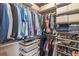 An organized walk-in closet with shelves, hanging rods, shoe racks and drawers offers ample storage at 3040 Peachtree Nw Rd # 1013, Atlanta, GA 30305