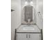 Bathroom vanity featuring granite countertop, sink, and decorative mirror at 4038 Sharon Woods Dr, Powder Springs, GA 30127