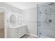 Bright bathroom with a double sink vanity, glass shower, and modern lighting at 4038 Sharon Woods Dr, Powder Springs, GA 30127