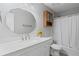 Bathroom featuring a vanity with storage, a round mirror, and a bathtub with shower at 4038 Sharon Woods Dr, Powder Springs, GA 30127