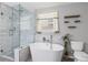 Beautiful bathroom with a freestanding tub, glass shower, and elegant marble-like tile at 4038 Sharon Woods Dr, Powder Springs, GA 30127