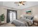 Staged bedroom with ceiling fan, french doors, and soothing colors creates a peaceful retreat at 4038 Sharon Woods Dr, Powder Springs, GA 30127