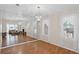 Dining room features hardwood floors, chandelier, and a wall of mirrors creating an elegant and spacious dining experience at 4038 Sharon Woods Dr, Powder Springs, GA 30127