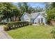 A well-maintained light blue residence showcasing a lush green lawn and a convenient two-car garage at 4038 Sharon Woods Dr, Powder Springs, GA 30127