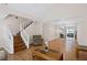 Spacious living room features staircase and open design flowing into a dining area, ideal for modern living at 4038 Sharon Woods Dr, Powder Springs, GA 30127