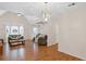 Living room features hardwood floors, chandelier and open layout flowing into a dining area, ideal for modern living at 4038 Sharon Woods Dr, Powder Springs, GA 30127