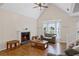 Cozy living room features a vaulted ceiling, fireplace, and large window, perfect for relaxation at 4038 Sharon Woods Dr, Powder Springs, GA 30127