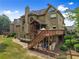 Two-story home with deck and patio, surrounded by well-maintained lawn at 4955 Winding Rose Dr, Suwanee, GA 30024