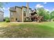 Expansive backyard featuring a two-story deck and lush green lawn at 4955 Winding Rose Dr, Suwanee, GA 30024