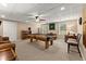 Finished basement with a pool table, carpet, paneled ceiling, and plenty of room for entertaining at 4955 Winding Rose Dr, Suwanee, GA 30024