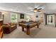 Finished basement with a pool table, carpet, paneled ceiling, comfortable seating and lots of room at 4955 Winding Rose Dr, Suwanee, GA 30024