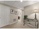 Basement hallway with paneled door, carpeted floor, small console table and a glimpse of a bathroom at 4955 Winding Rose Dr, Suwanee, GA 30024