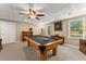Spacious finished basement with a pool table, carpet, neutral walls, and paneled ceiling at 4955 Winding Rose Dr, Suwanee, GA 30024