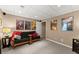 Finished basement with carpet, futon, and multiple framed posters at 4955 Winding Rose Dr, Suwanee, GA 30024