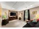 Finished basement with carpet, mounted tv, and a sofa at 4955 Winding Rose Dr, Suwanee, GA 30024