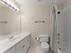 Standard bathroom with a shower/tub combination and white fixtures and striped shower curtain at 4955 Winding Rose Dr, Suwanee, GA 30024