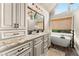 Bathroom boasts a granite countertop, cabinets, double sinks, and a soaking tub at 4955 Winding Rose Dr, Suwanee, GA 30024