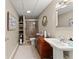 Well-lit bathroom featuring a glass door shower, decorative wreath, and white pedestal sink at 4955 Winding Rose Dr, Suwanee, GA 30024